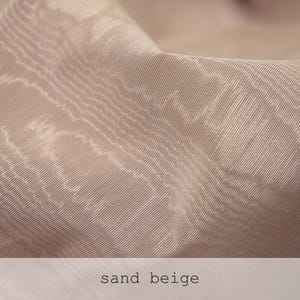 Neutral oatmeal beige fabric texture close-up with a soft sheen and horizontal rippled pattern. Ideal for neutral tone flat lays, organic modern decor, and clean minimalist product design.