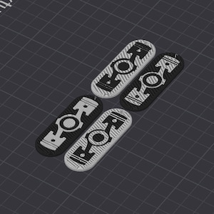 May include: Four black and white patterned metal keychains with a design of a piston. The keychains are arranged in a staggered pattern.