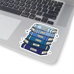 May include: A sticker depicting a stack of books in various shades of blue. The books are labelled with subjects: Fiction, History, Science, Nature, Art, and Music. The sticker has a white border and star accents.