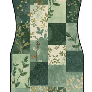 May include: A rectangular car floor mat with rounded corners and a black border, featuring a patchwork design of various shades of green and cream. The pattern consists of botanical illustrations of leaves, stems, and floral motifs in a grid.