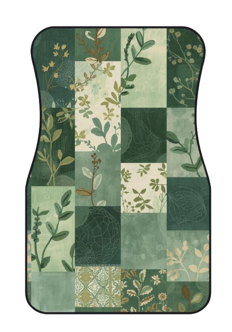 May include: A rectangular car floor mat with rounded corners and a black border, featuring a patchwork design of various shades of green and cream. The pattern consists of botanical illustrations of leaves, stems, and floral motifs in a grid.