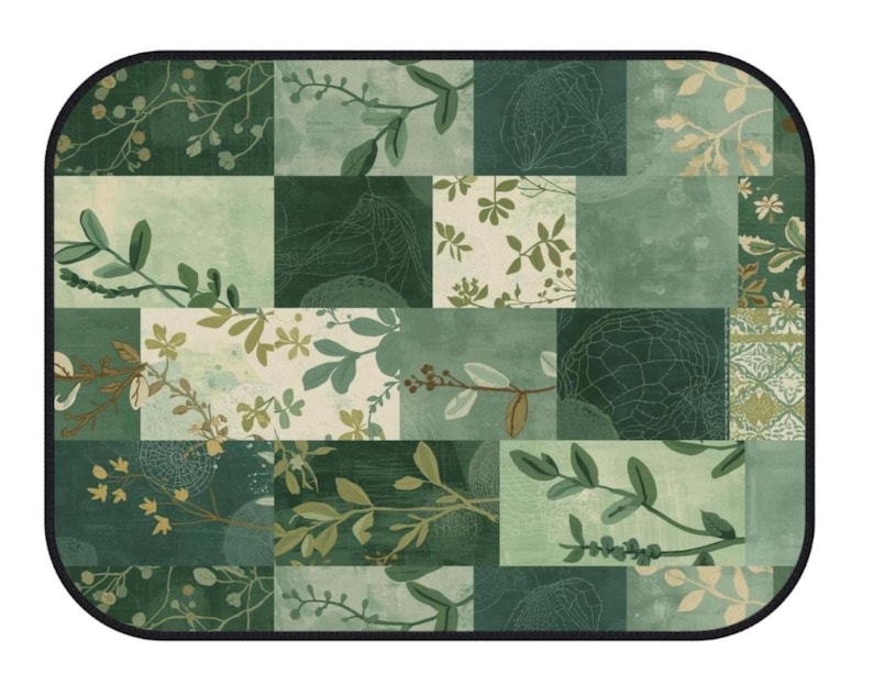 May include: A rectangular mat with rounded corners featuring a patchwork design in various shades of green. The pattern consists of multiple squares and rectangles displaying botanical illustrations of leaves, branches, flowers, and intricate line art.