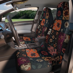 Pode incluir: Um par de capas para bancos de carro com um design de patchwork de vários padrões florais em tons de laranja, azul escuro, vermelho e creme. As capas estão instaladas nos bancos dianteiros de um veículo, exibindo uma grade de motivos.