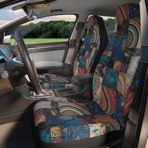 May include: A pair of car seat covers featuring a vibrant patchwork design with intricate mandala-inspired patterns in shades of deep blue, teal, orange, and cream. The fabric covers the front and backrests of the vehicle seats, providing a full-coverage look.