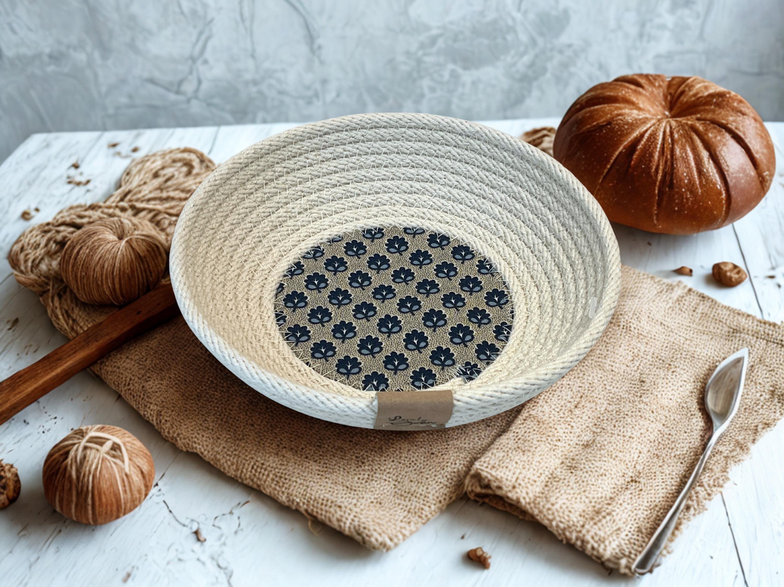 Gracefully shaped round cotton rope bowl with a small blue floral fabric inserted in the base.