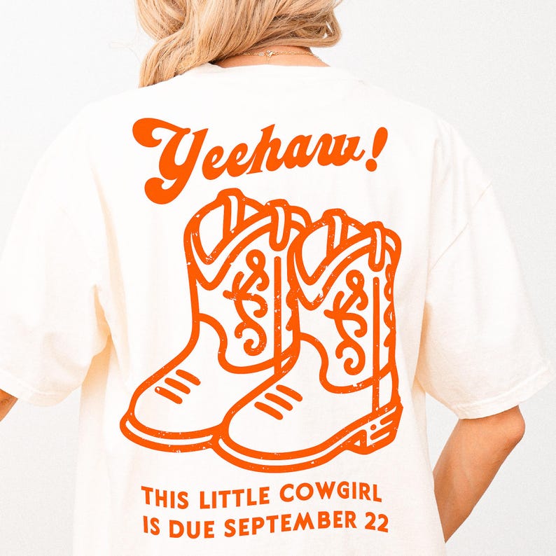 May include: A white t-shirt with an orange graphic of cowboy boots and the text "Yeehaw! This little cowgirl is due September 22".