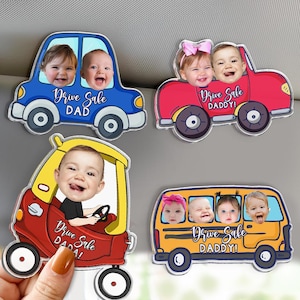 May include: Four car-shaped magnets with smiling baby faces. The magnets are in the shape of a blue car, a red car, a yellow car, and a yellow school bus. Each magnet has the words "Drive Sale" and "DAD" or "DADDY!" printed on them.
