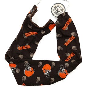 May include: Brown and orange stethoscope cover with a repeating pattern of football helmets and the word "Browns".