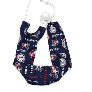 May include: A navy blue stethoscope cover featuring the Columbus Blue Jackets logo and team name in white and red. The cover is patterned with team logos and text, including "COLUMBUS BLUE JACKETS" and "#1 TEAM".