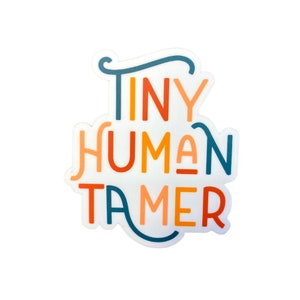 May include: White sticker with the text "Tiny Human Tamer" in colorful, stylized lettering. The letters are in shades of orange, yellow, red, and blue.
