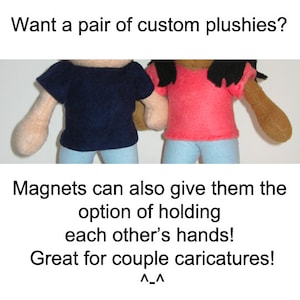 May include: Two custom plush toys, one wearing a navy blue shirt and the other wearing a pink shirt, are holding hands. The text "Magnets can also give them the option of holding each other's hands! Great for couple caricatures! ^_^" is below the image.