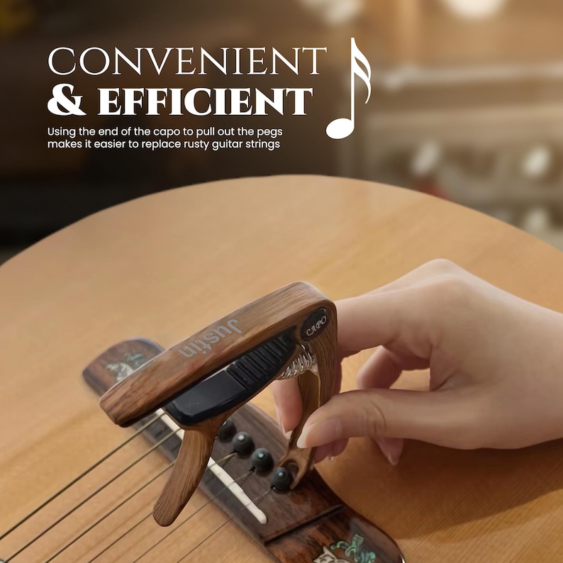 May include: A wooden capo with a black spring and a black lever. The capo is attached to a guitar fretboard. The text "uishe CAPO" is printed on the capo.