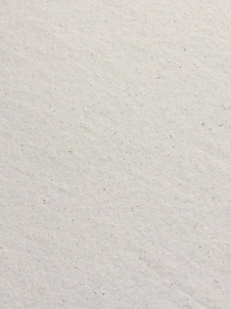 May include: A close-up of a white textured surface with a subtle grainy pattern.