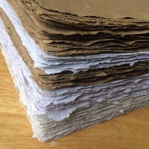 10 sheets of 8.5x11 inch handmade recycled paper, available in brown, white, tan, and floral