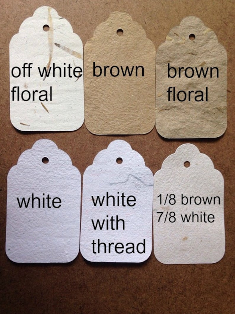 May include: Six paper gift tags with different colors and patterns. The tags are off white floral, brown, brown floral, white, white with thread, and 1/8 brown 7/8 white.