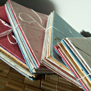 10 assorted colors of handmade recycled paper envelopes, available in multiple sizes