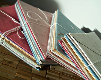 10 assorted colors of handmade recycled paper envelopes, available in multiple sizes