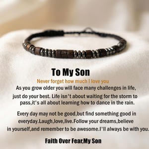May include: A beaded bracelet with dark wooden and metallic beads. The bracelet is on a white surface, with text that reads "To My Son" and a motivational message. The bracelet is a thoughtful gift.