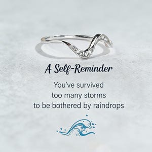 May include: A silver-colored ring with a wave design, adorned with small, clear gemstones. The image includes the text "A Self-Reminder" and a motivational quote about overcoming challenges.