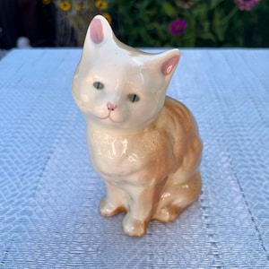 Ceramic Cat with Orange Hue and Blue Eyes