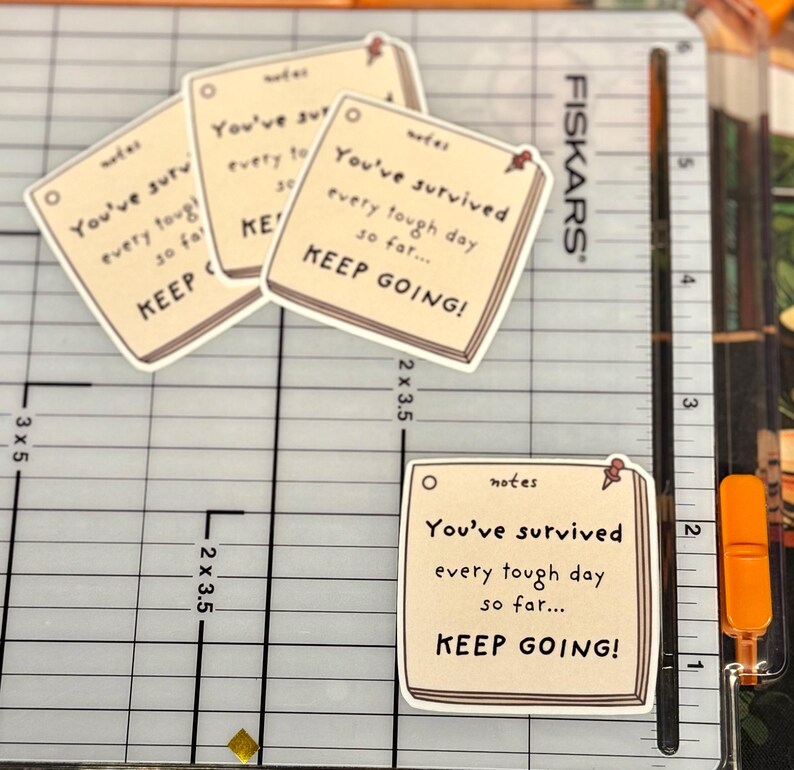 May include: Four square stickers shaped like sticky notes with a cream background and black text that reads: notes, You've survived every tough day so far... KEEP GOING! Each sticker features a small red pushpin graphic in the top right corner.
