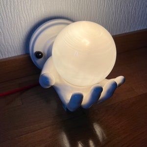 Weird wall lamp from 80&#39;s, ceramic hand holding glass ball.