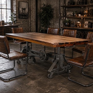 May include: A rectangular wooden dining table with a thick top and a dark metal industrial base featuring a hand crank and wheels, surrounded by six brown leather chairs with metal cantilever frames and stitched grid patterns on the backrests.