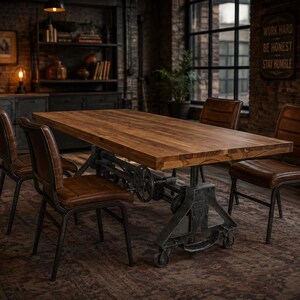 May include: A rectangular wooden dining table with a thick brown top and a black metal industrial base featuring a hand crank mechanism, accompanied by four brown leather chairs with horizontal stitching and black metal frames.