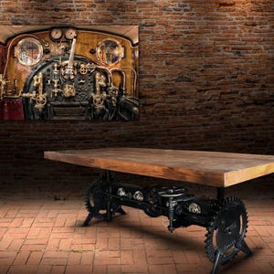May include: A rectangular wooden table with a dark finish, supported by a black metal base featuring gears and mechanical components. A framed artwork depicting a steampunk-style machine hangs on the brick wall.