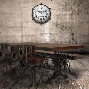 May include: An industrial-style dining set with a wooden tabletop and metal base. The set includes a table, chairs, and a bench. A large clock hangs on the wall above the table. Two potted plants flank the table, adding a touch of greenery.