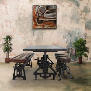 May include: A rustic dining table set with a gray metal top and black metal legs. The table is paired with a brown leather bench and two black metal bar stools with brown leather seats. A metal wall art piece depicting a vintage car is displayed on the wall behind the table.