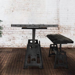 May include: A black metal table and bench set with a wood top. The table and bench have a rustic industrial style.