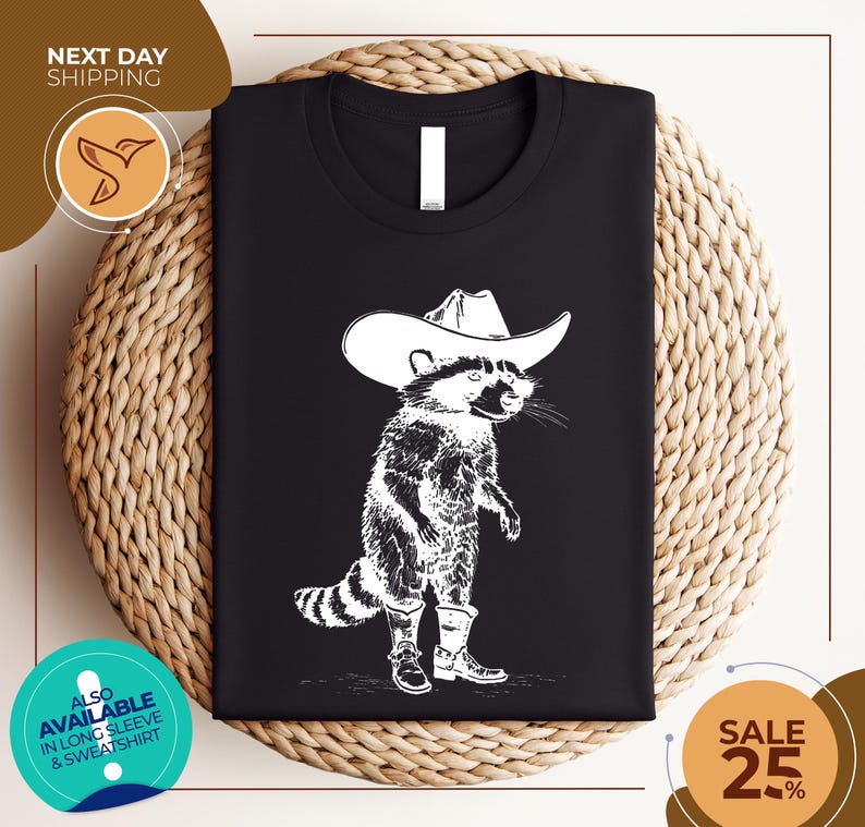 a black shirt with a raccoon wearing a cowboy hat