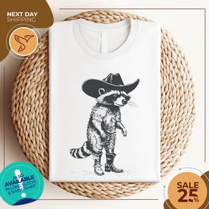 a white shirt with a raccoon wearing a cowboy hat
