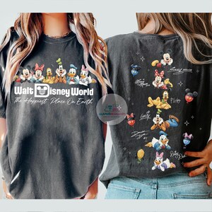 May include: Dark grey t-shirt with a Walt Disney World design. It features Mickey Mouse, Minnie Mouse, and other characters. The front of the shirt has the text "Walt Disney World The Happiest Place On Earth."
