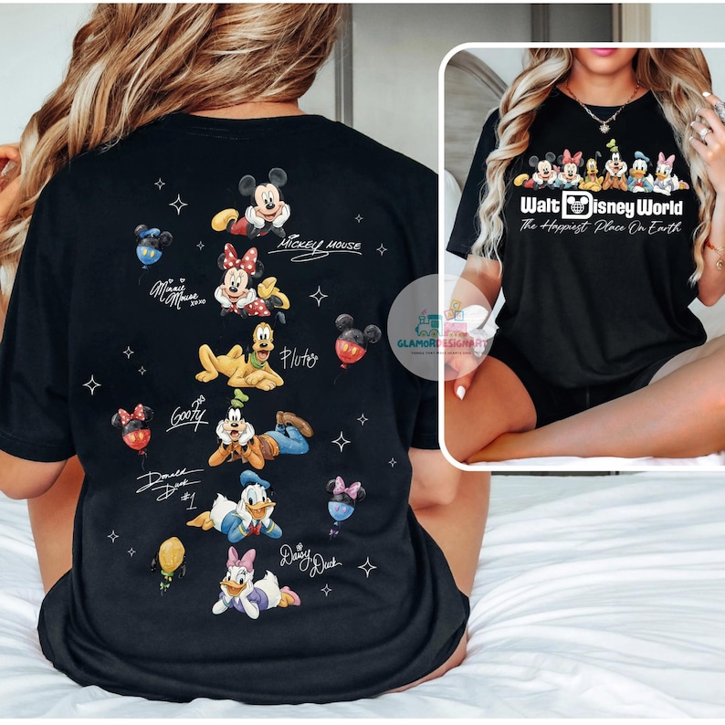 May include: Black t-shirt featuring Disney characters Mickey Mouse, Minnie Mouse, Pluto, Goofy, Donald Duck, and Daisy Duck. The back of the shirt has character illustrations and signatures. The front of the shirt has the text "Walt Disney World The Happiest Place On Earth".