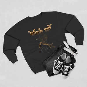 May include: Black sweatshirt with a gold graphic print of a figure with the text "infinite void" above it. The figure is surrounded by stars and the words "cloud" and "saturn" are written on either side of the figure.