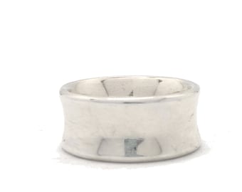 May include: A wide, silver-colored ring with a curved design. The ring has a smooth, polished surface and a simple, elegant style. The ring is likely made of sterling silver or a similar metal.