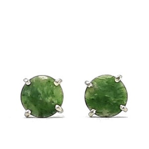 May include: A pair of silver stud earrings with green jade stones.