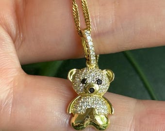 Adorable teddy bear pendant is 14K gold plated sterling silver and accented with genuine diamonds
