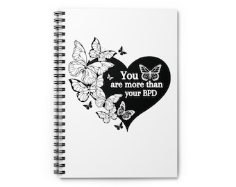 May include: A white spiral notebook with a black heart design featuring butterflies and the text "You are more than your BPD".
