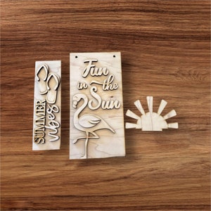 May include: Three wooden cutouts for a summer themed craft project. The first cutout says "Summer vibes" with a pair of flip flops. The second cutout says "Fun in the Sun" with a flamingo. The third cutout is a stylized sun.