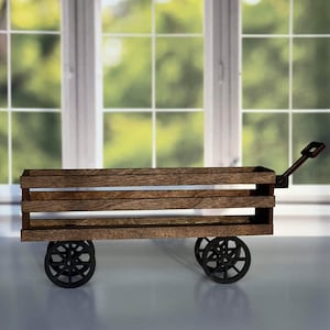 May include: A wooden wagon with black wheels and a handle. The wagon has three shelves and is made of dark wood.