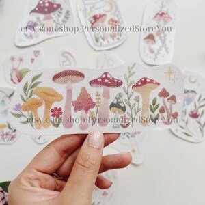 May include: A set of iron-on patches featuring colorful mushrooms and foliage. The patches are perfect for adding a whimsical touch to clothing, bags, or other fabric items. etsy.com/shop/PersonalizedStoreYou