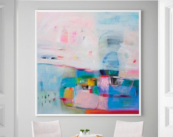 May include: Abstract painting in a white frame, with a mix of pink, blue, and turquoise colours. The artwork hangs above two light-coloured armchairs and a small table. A patterned rug and open white doors complete the scene.