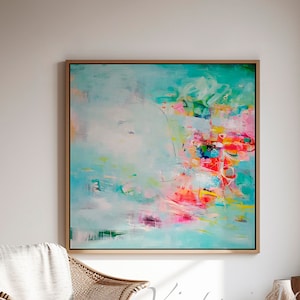 May include: Abstract painting with a turquoise background and colorful brushstrokes in pink, yellow, green, and red. The painting is framed in a light wood frame and is hanging on a white wall.