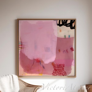 May include: Large abstract painting with a pink and neutral color palette. The artwork features brushstrokes and shapes in shades of pink, red, and black. The painting is displayed in a light wood frame, creating a focal point in a bright, airy room.