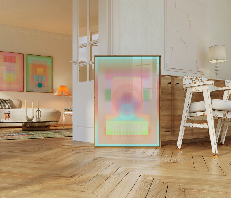 May include: Abstract art print with a pink, blue, and green color scheme. The print is framed in a light wood frame and is hanging on a white wall.