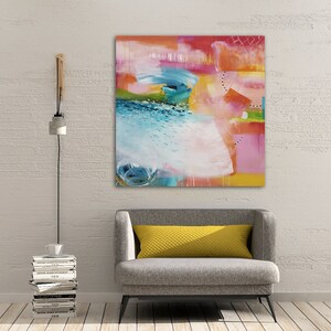 May include: Abstract painting with bright colors, including pink, yellow, blue, and green. The painting has a textured look and is framed in a white frame.