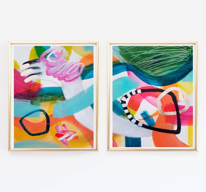 Puede incluir: Dos pinturas abstractas enmarcadas con pinceladas coloridas y formas geom&eacute;tricas. Las pinturas est&aacute;n en marcos dorados y tienen un fondo blanco.